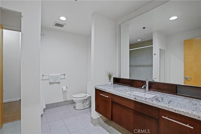 bathroom with vanity, toilet, and tile patterned flooring