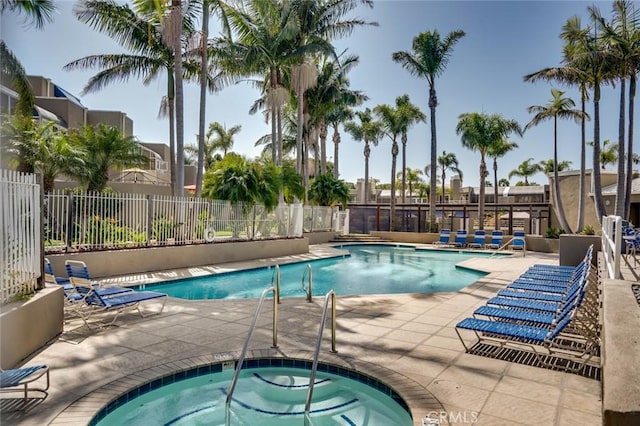 view of pool with a community hot tub and a patio area