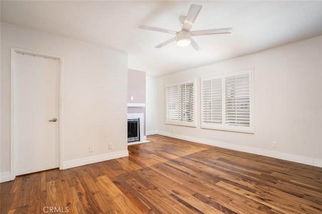 unfurnished living room with ceiling fan and wood-type flooring