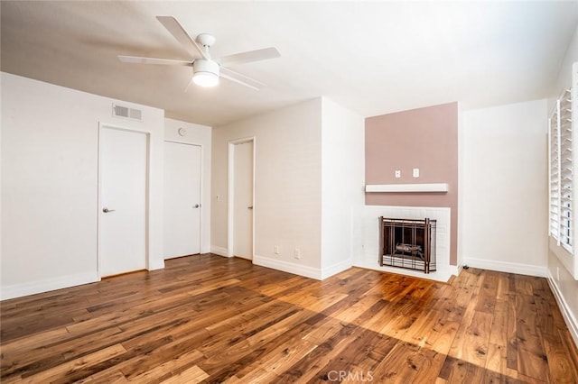 unfurnished living room with wood-type flooring and ceiling fan