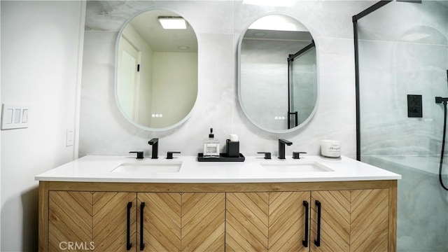 bathroom with walk in shower and vanity