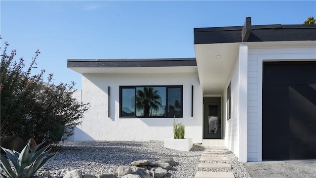 view of exterior entry with a garage