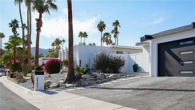 view of side of home featuring a garage and a mountain view