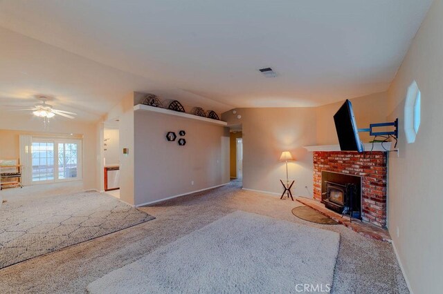 unfurnished living room with a fireplace, ceiling fan, and carpet flooring