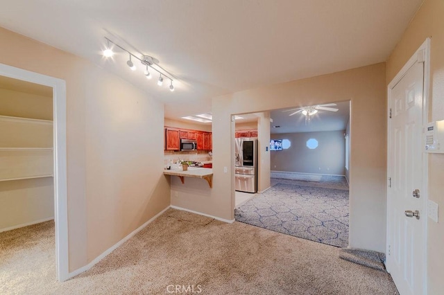 hallway featuring light carpet