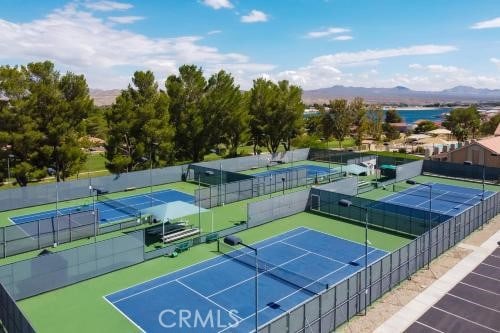 view of tennis court with a mountain view