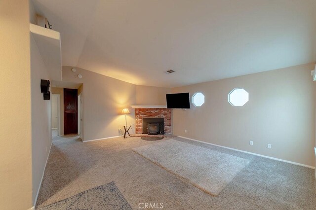 unfurnished living room featuring vaulted ceiling and carpet floors