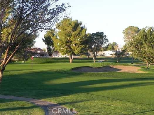 view of home's community with a yard