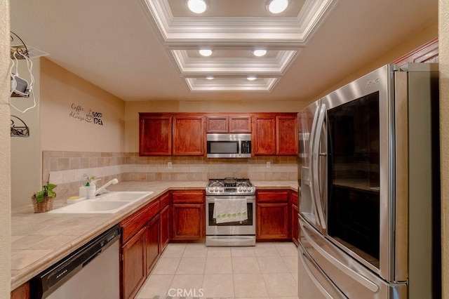 kitchen with appliances with stainless steel finishes, sink, decorative backsplash, light tile patterned floors, and a raised ceiling