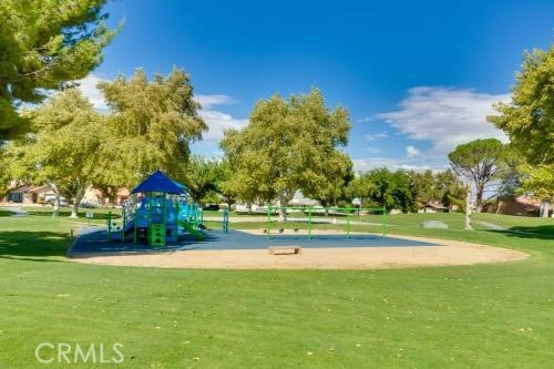 view of property's community featuring a lawn and a playground