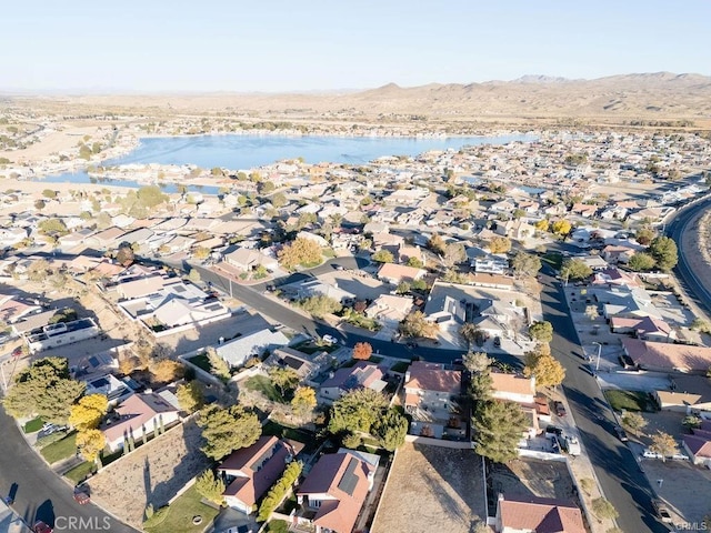 birds eye view of property with a water and mountain view