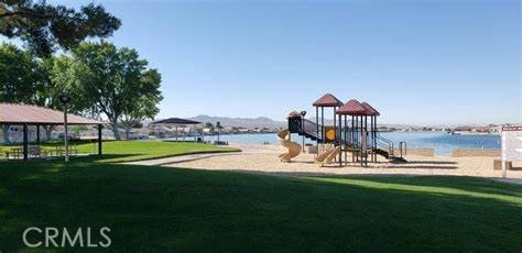 view of playground featuring a water view and a yard