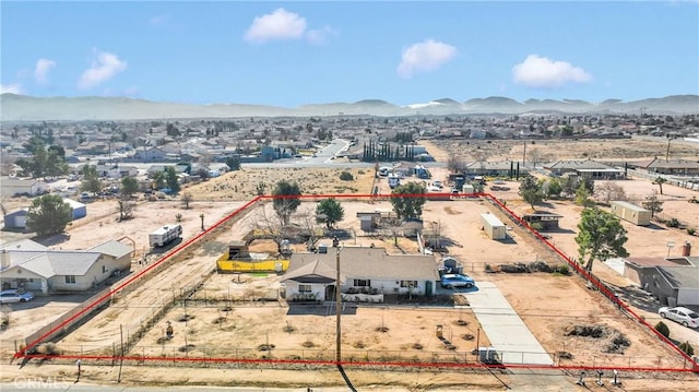 birds eye view of property with a mountain view