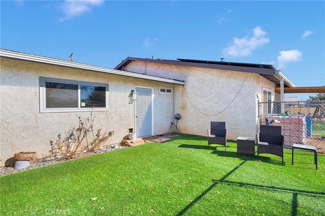 back of house featuring a yard