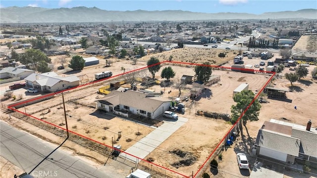 birds eye view of property with a mountain view