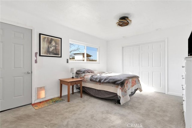 bedroom featuring light carpet and a closet