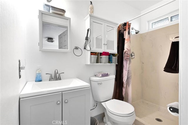 bathroom featuring vanity, toilet, and a shower with shower curtain