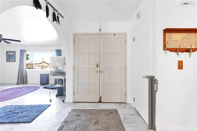 entrance foyer with ceiling fan