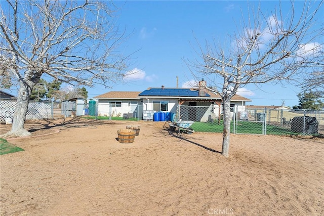 back of property featuring solar panels