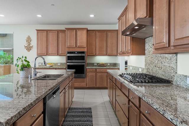 kitchen with sink, light tile patterned floors, appliances with stainless steel finishes, light stone countertops, and backsplash