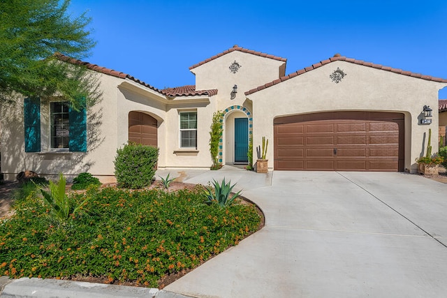 mediterranean / spanish-style home featuring a garage