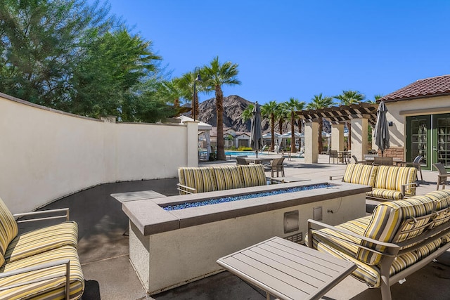 view of patio featuring a pool, an outdoor living space with a fire pit, and a pergola