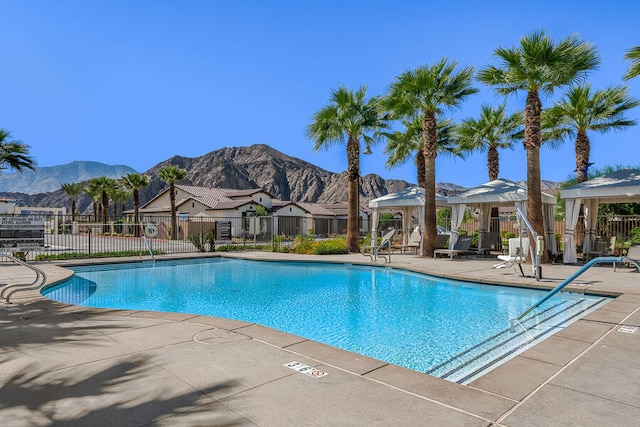 view of pool with a gazebo, a mountain view, and a patio