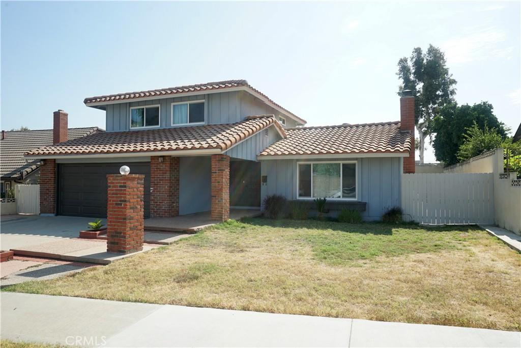 view of property with a garage and a front lawn