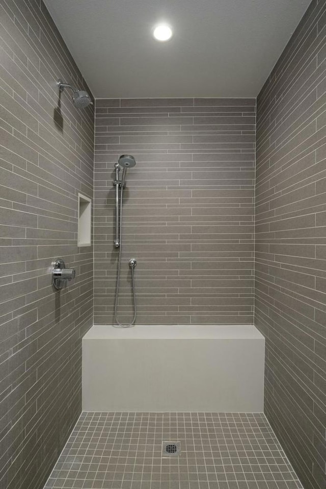 bathroom with a tile shower