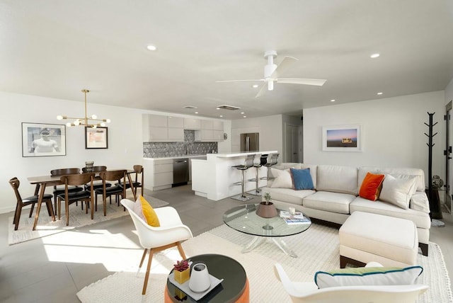 living room with light tile patterned flooring and ceiling fan with notable chandelier