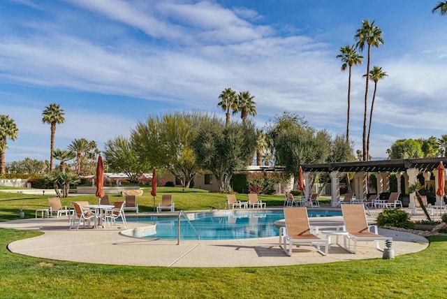 view of pool featuring a patio, a pergola, and a lawn