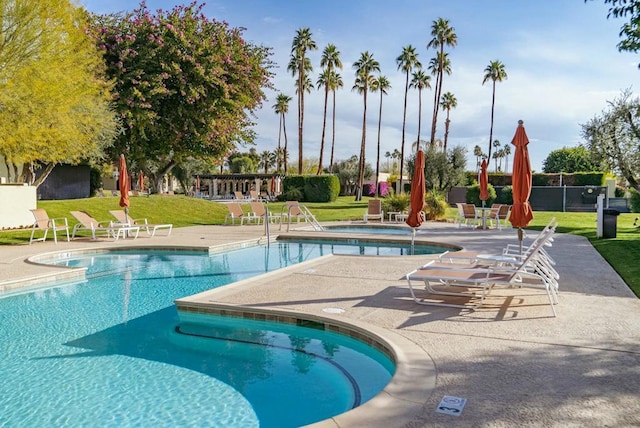 view of pool with a patio, a yard, and a pergola