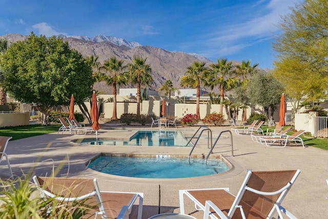 view of pool featuring a mountain view and a patio area