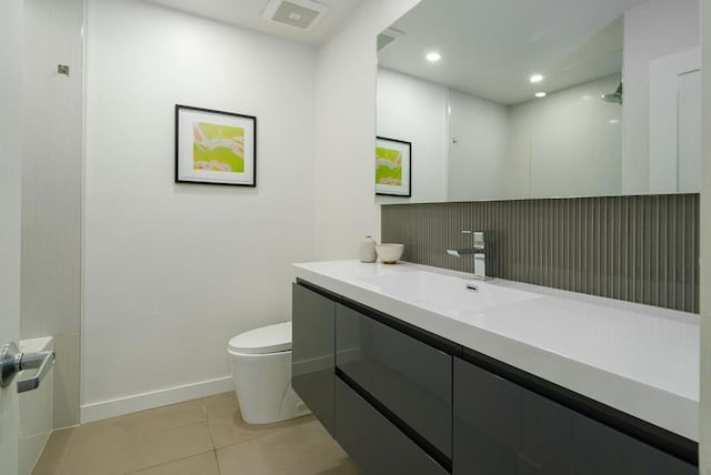 bathroom with vanity, tile patterned floors, and toilet