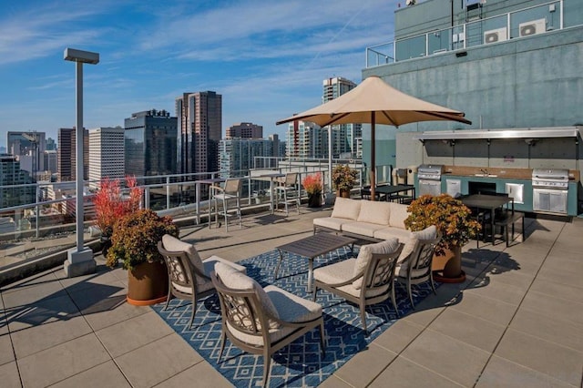 view of patio / terrace with a grill, an outdoor hangout area, and exterior kitchen