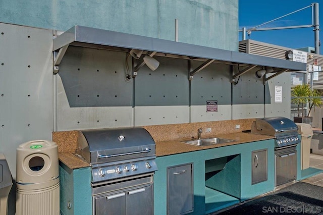 view of patio with area for grilling, exterior kitchen, and sink