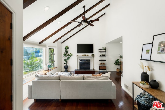 living room featuring high vaulted ceiling, beamed ceiling, dark hardwood / wood-style flooring, ceiling fan, and a high end fireplace