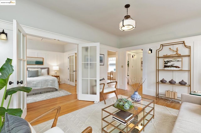 living room featuring french doors and light hardwood / wood-style flooring