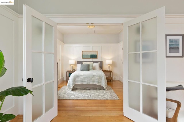 bedroom featuring wood-type flooring and french doors