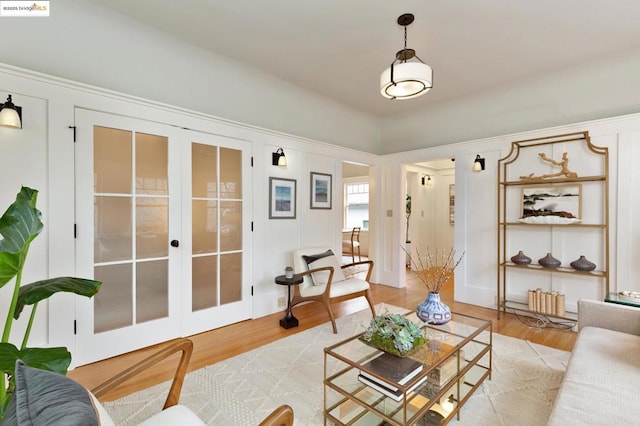 living room featuring french doors and light wood-type flooring