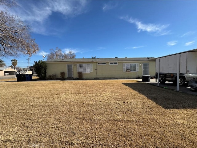 rear view of property with a yard