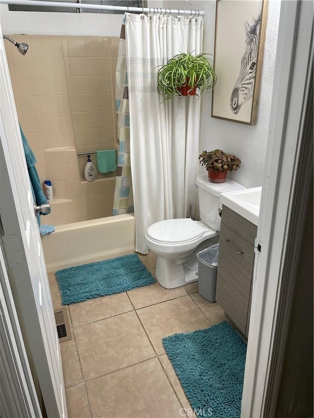 full bathroom with tile patterned flooring, vanity, shower / bathtub combination with curtain, and toilet