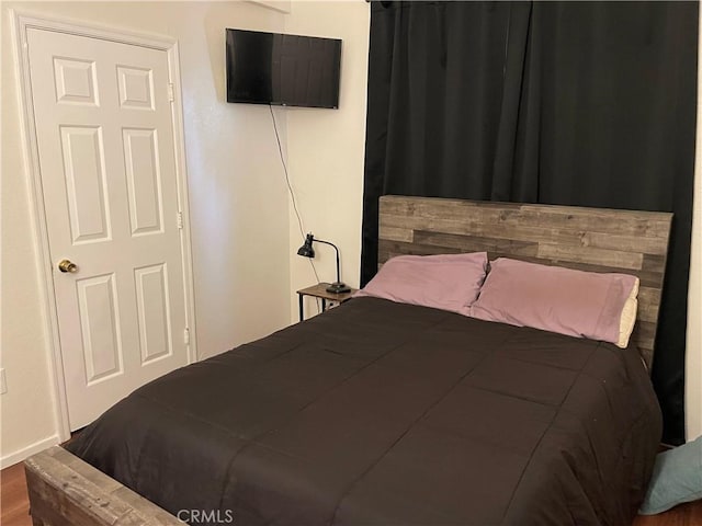 bedroom with wood-type flooring