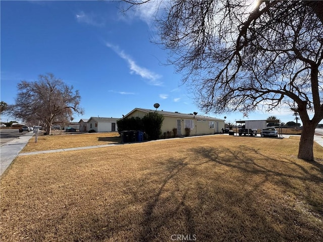 view of side of property featuring a yard