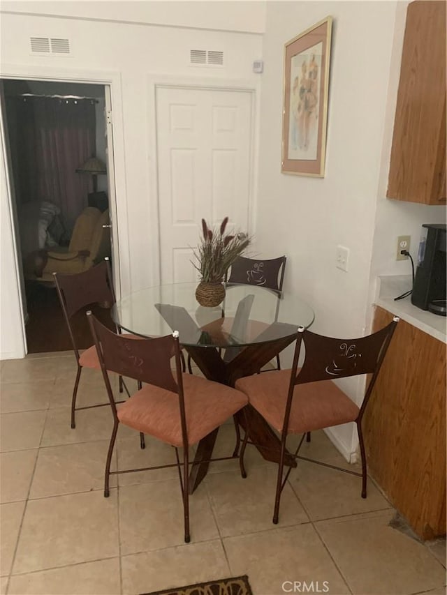 dining space featuring light tile patterned floors