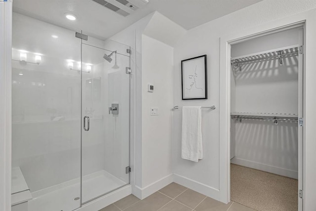 bathroom featuring an enclosed shower and tile patterned flooring