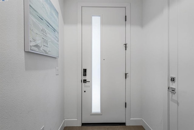 entryway with hardwood / wood-style floors