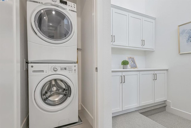 laundry area featuring stacked washing maching and dryer