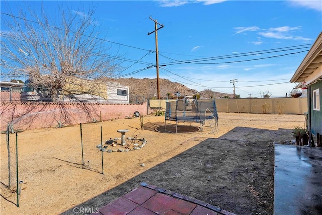 view of yard featuring a trampoline and a patio area