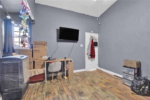 home office featuring vaulted ceiling and hardwood / wood-style floors